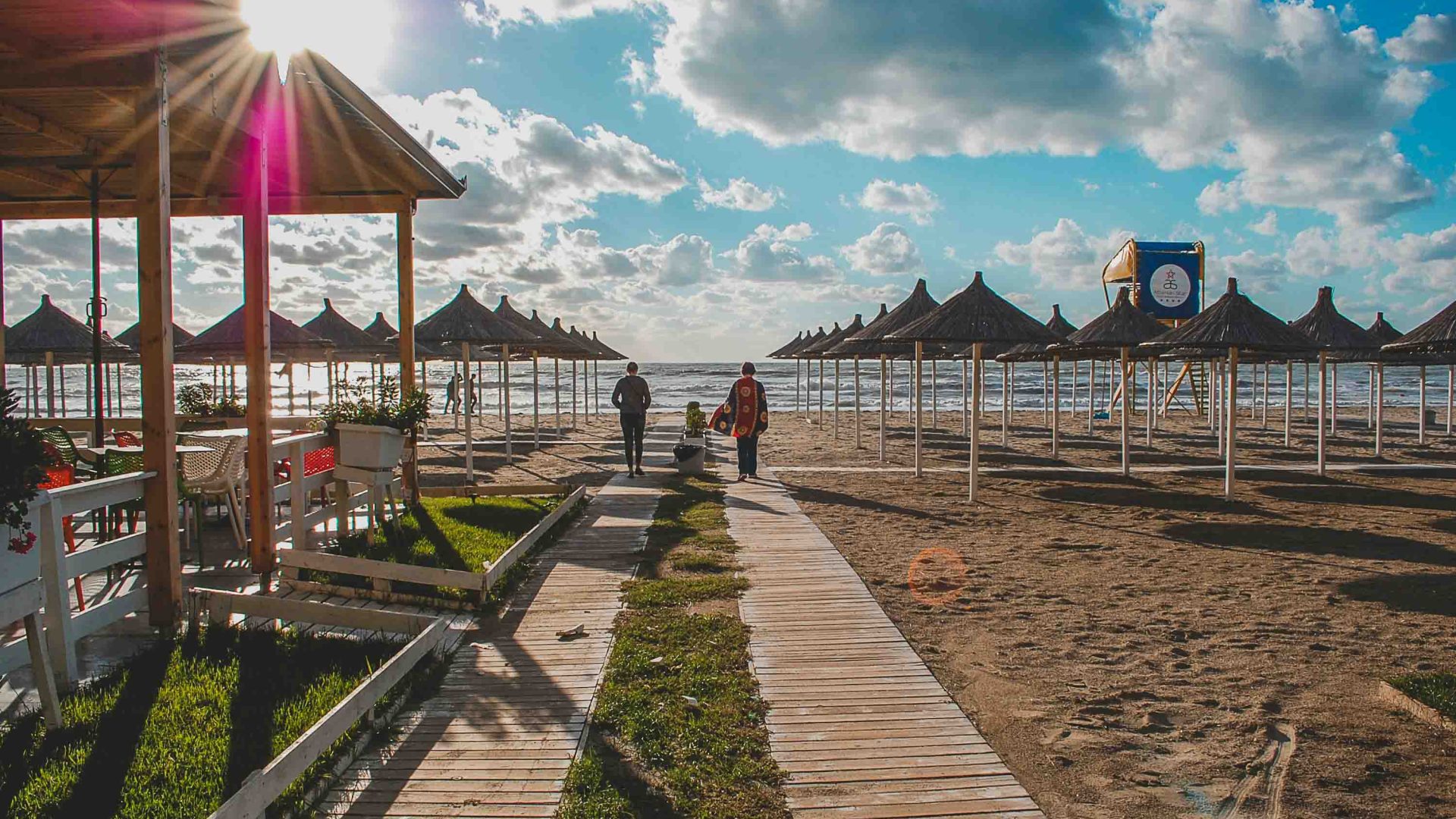 People walk by the seaside.