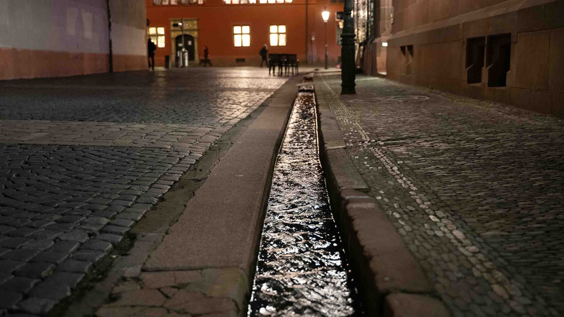 A canal running through the streets at night.