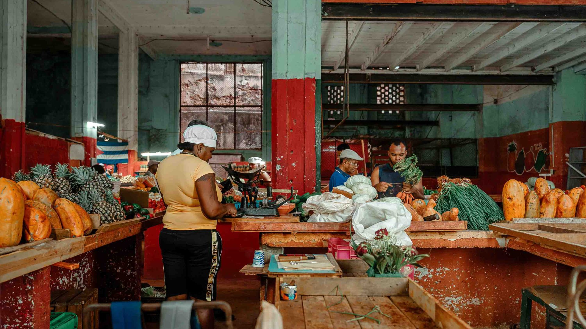 A woman works in a produce store .