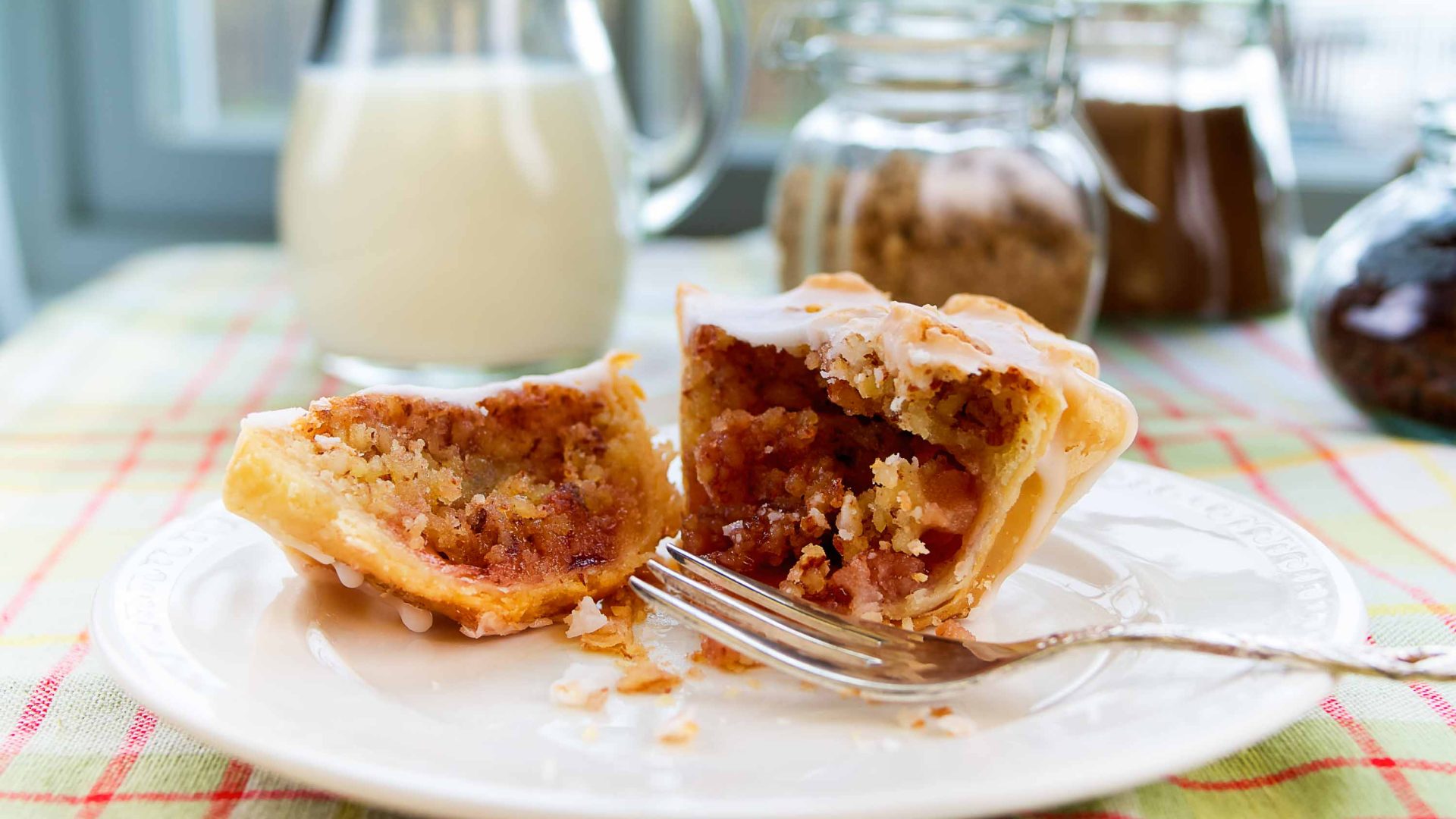 A bakewell tart on a plate with a fork.