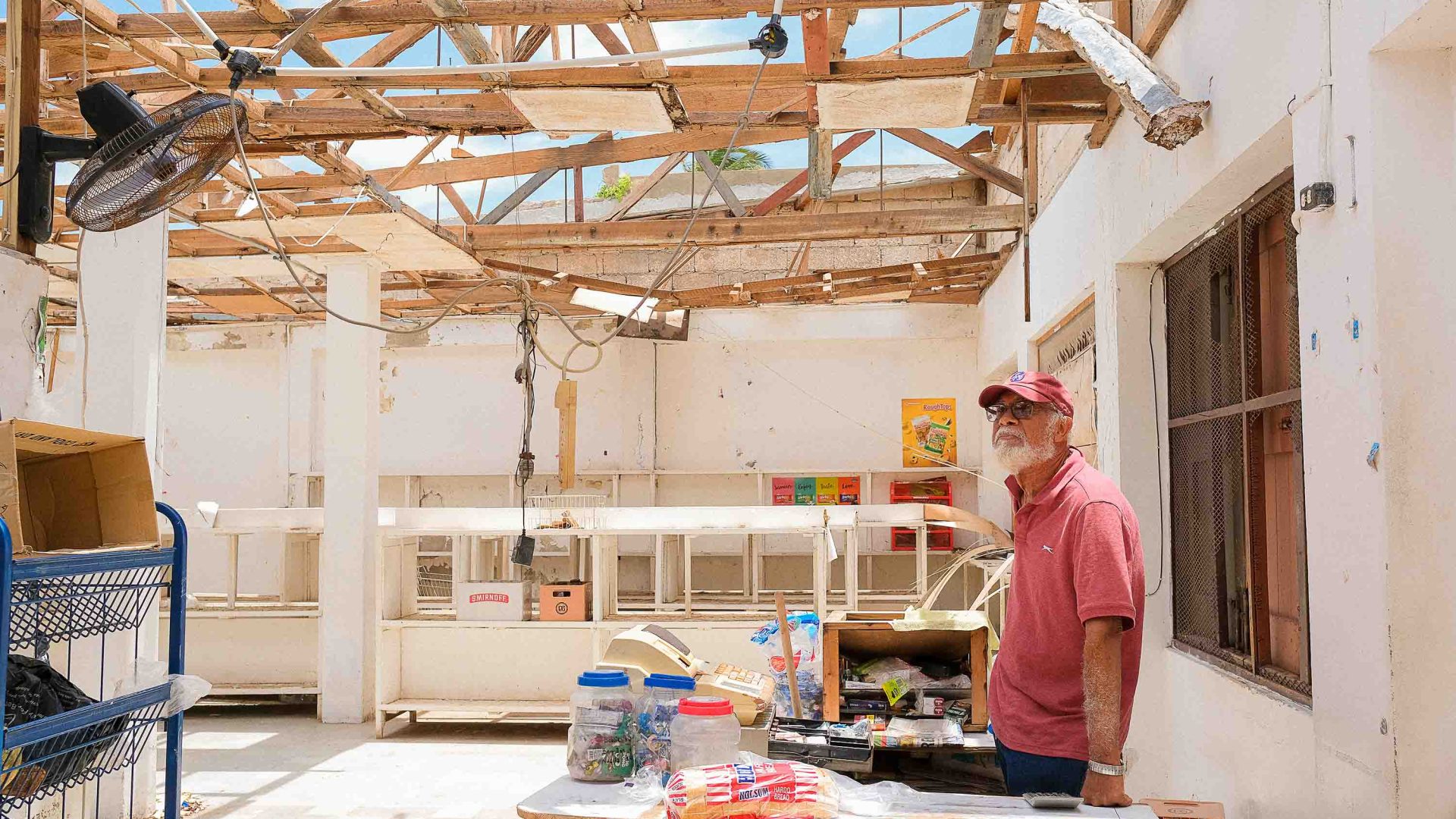 A man stands in a store with no roof.