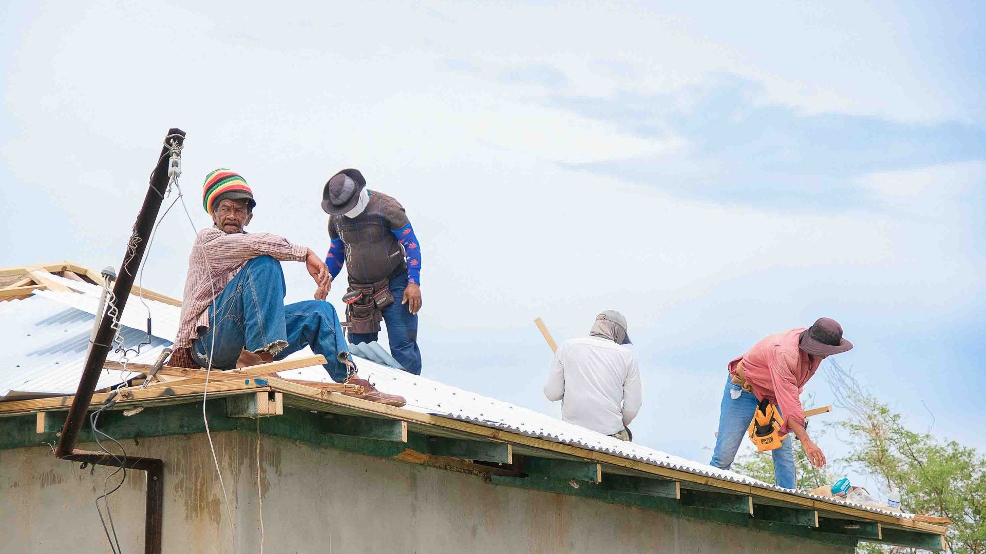 Men work to fix a roof.