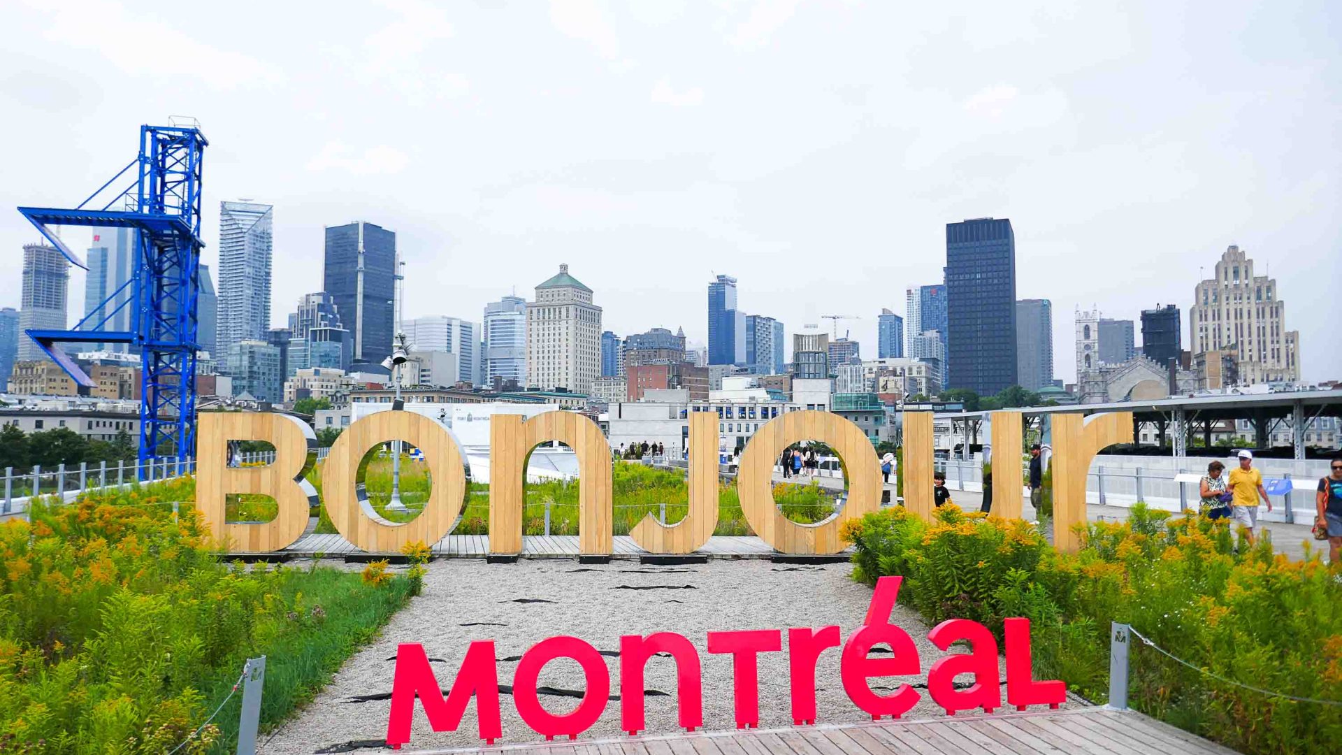 The words 'Bonjour Montreal' stand in front of the city skyline.