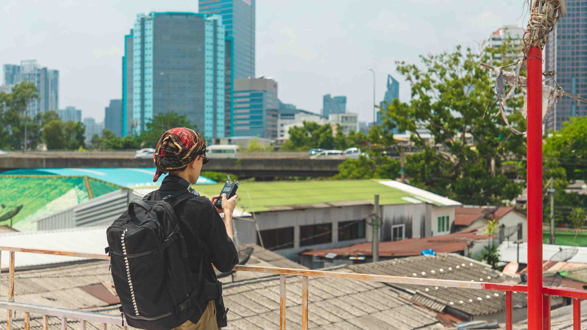 A person records the sounds on the outskirts of the city.