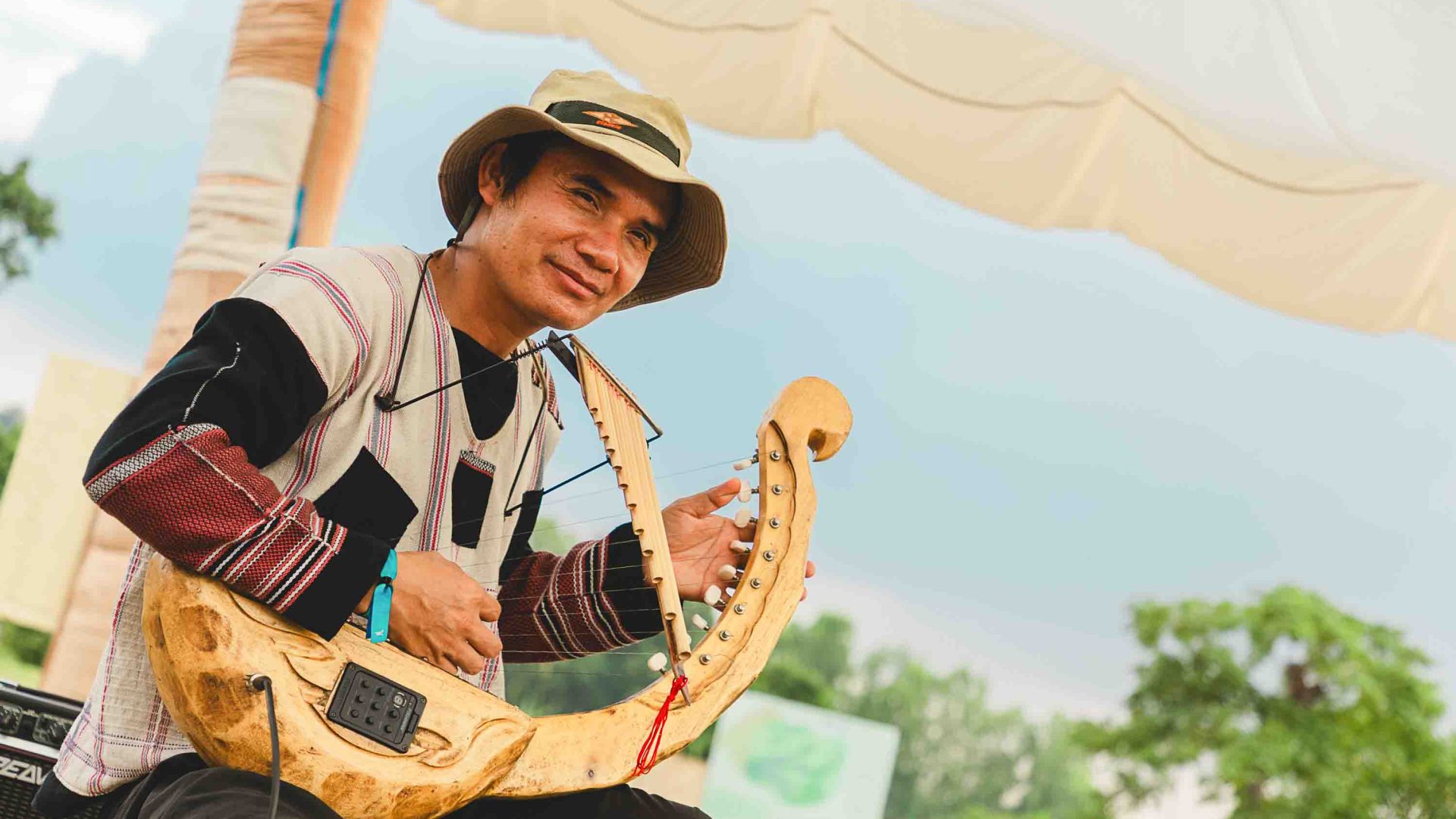 A man plays an instrument at a Tae Na Gu workshop.