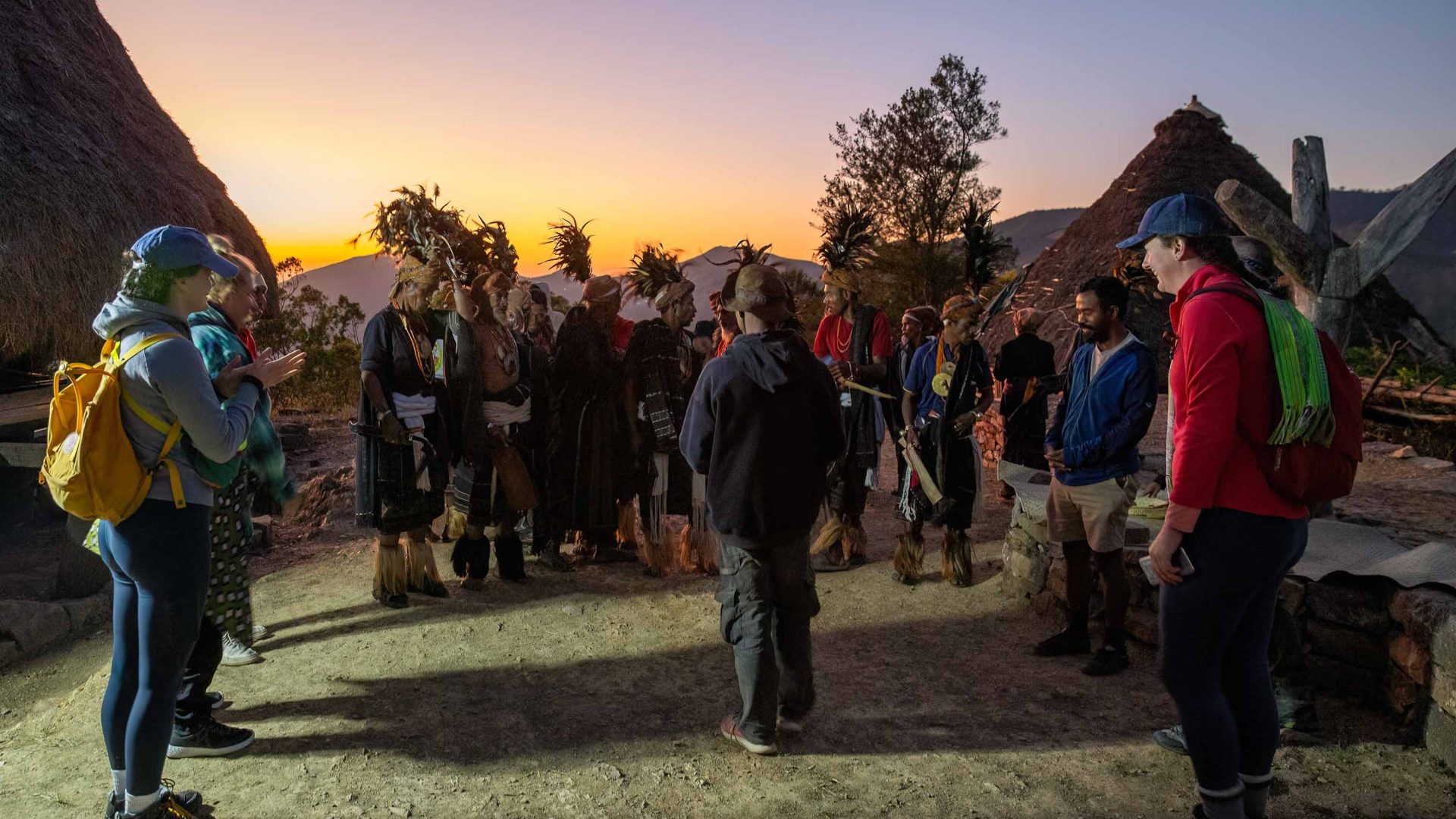 Travelers participate in a welcome ceremony.